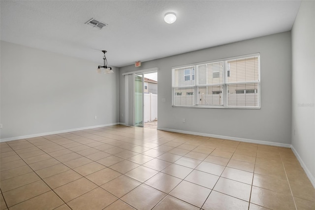 5118 Adelaide Dr, Kissimmee, FL 34746 - spare room with a chandelier, visible vents, baseboards, and light tile patterned flooring