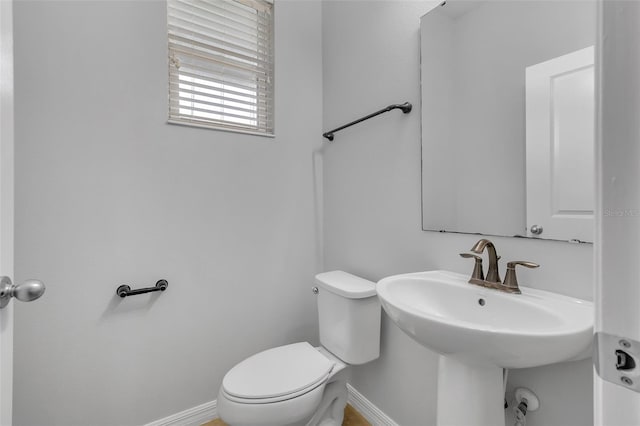 5118 Adelaide Dr, Kissimmee, FL 34746 - bathroom with toilet, baseboards, and a sink