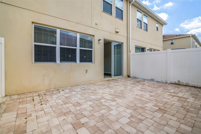 5118 Adelaide Dr, Kissimmee, FL 34746 - rear view of property with a patio, stucco siding, and fence