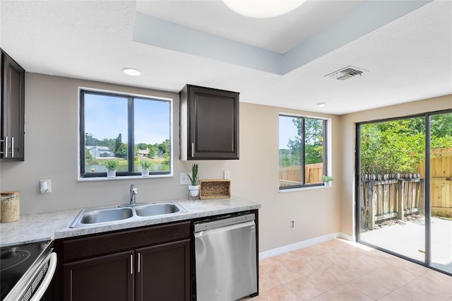 kitchen featuring visible vents, appliances with stainless steel finishes, a sink, light countertops, and light tile patterned flooring