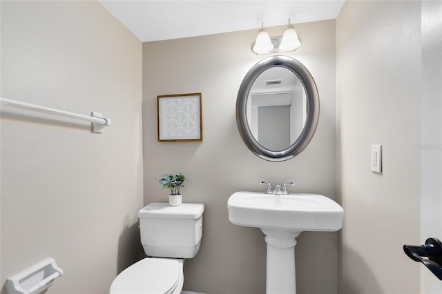 bathroom featuring toilet and visible vents