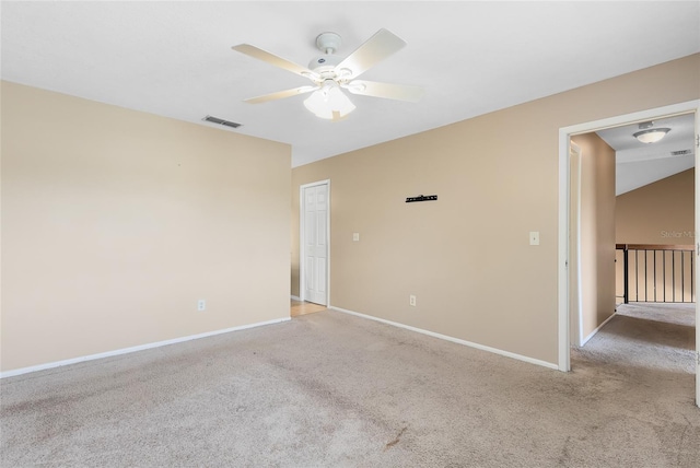 empty room with a ceiling fan, baseboards, light colored carpet, and visible vents