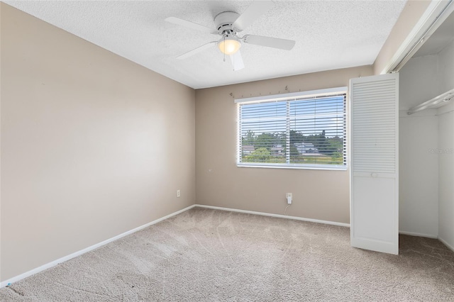 unfurnished bedroom featuring baseboards, carpet flooring, and a textured ceiling