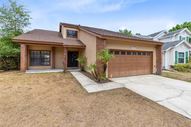 single story home featuring driveway, roof with shingles, a front yard, an attached garage, and stucco siding