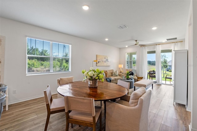 dining area with visible vents, light wood-style flooring, and a wealth of natural light