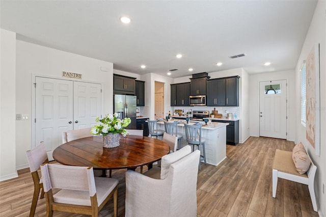 dining area featuring visible vents, recessed lighting, light wood finished floors, and baseboards