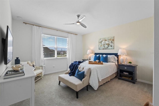 bedroom with baseboards, light carpet, and a ceiling fan