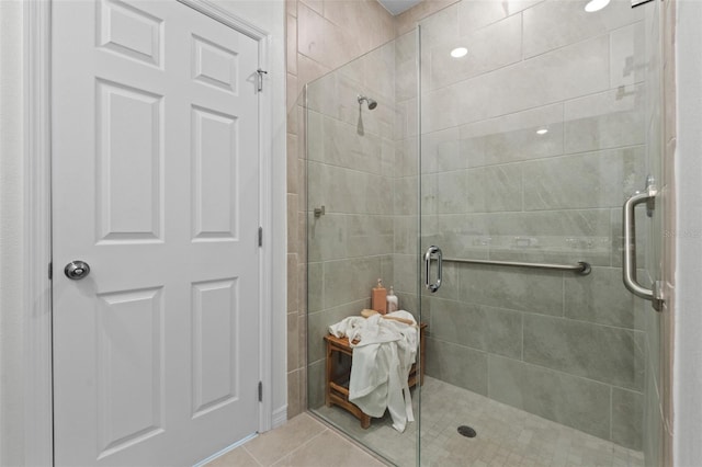 full bathroom featuring tile patterned flooring and a stall shower
