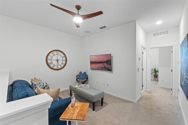 living area featuring ceiling fan, carpet flooring, and visible vents