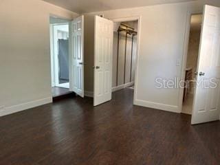 unfurnished bedroom featuring baseboards and wood finished floors