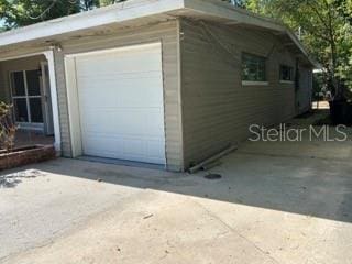 garage with concrete driveway