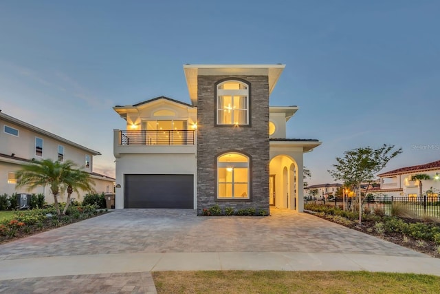 7905 Jacks Club Dr, Kissimmee, FL 34747 - view of front of home featuring a balcony, fence, stucco siding, decorative driveway, and an attached garage