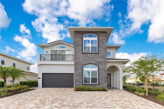 7905 Jacks Club Dr, Kissimmee, FL 34747 - view of front of home featuring a balcony, stucco siding, a garage, fence, and driveway