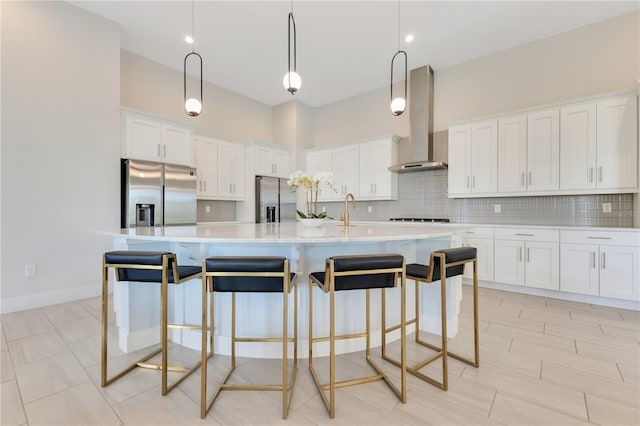7905 Jacks Club Dr, Kissimmee, FL 34747 - kitchen with stainless steel refrigerator with ice dispenser, wall chimney exhaust hood, decorative backsplash, and white cabinetry