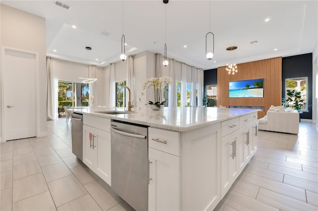 7905 Jacks Club Dr, Kissimmee, FL 34747 - kitchen with open floor plan, stainless steel dishwasher, a kitchen island with sink, a sink, and recessed lighting