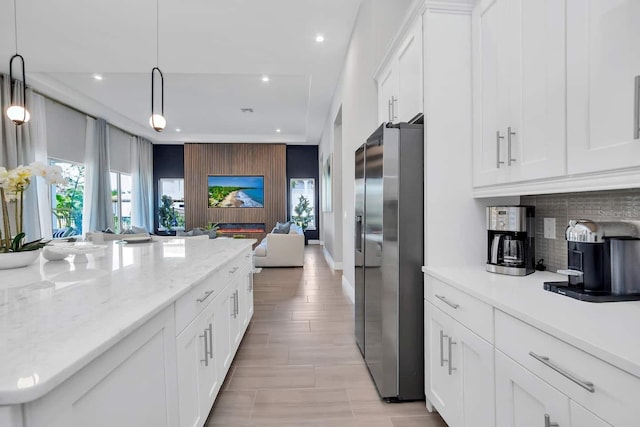 7905 Jacks Club Dr, Kissimmee, FL 34747 - kitchen with stainless steel refrigerator with ice dispenser, open floor plan, tasteful backsplash, recessed lighting, and white cabinetry