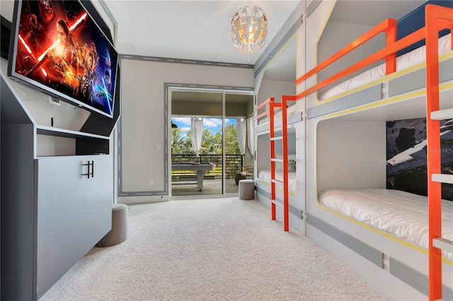 7905 Jacks Club Dr, Kissimmee, FL 34747 - carpeted bedroom featuring access to exterior and a chandelier