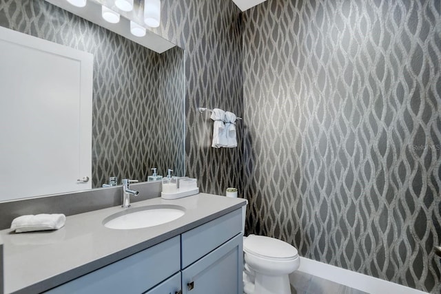 7905 Jacks Club Dr, Kissimmee, FL 34747 - bathroom featuring wallpapered walls, vanity, and toilet