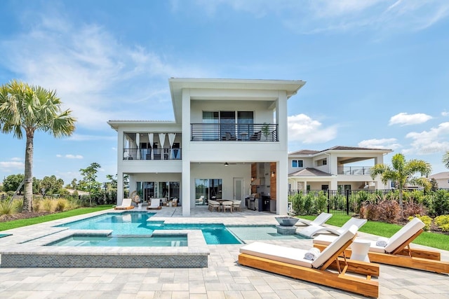 7905 Jacks Club Dr, Kissimmee, FL 34747 - back of property with a balcony, a patio, stucco siding, fence, and a pool with connected hot tub