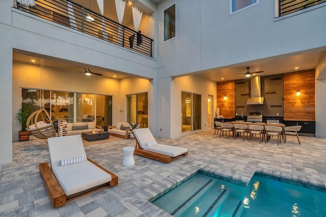 7905 Jacks Club Dr, Kissimmee, FL 34747 - rear view of house featuring an outdoor living space with a fire pit, a ceiling fan, a patio, and stucco siding