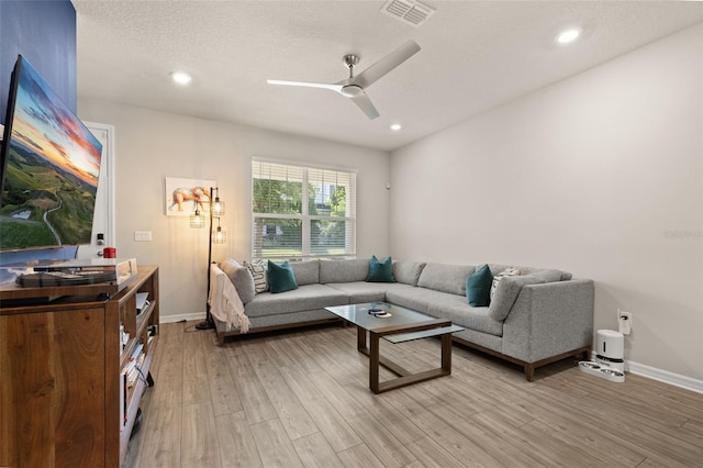 living room with light wood-style floors, ceiling fan, baseboards, and recessed lighting