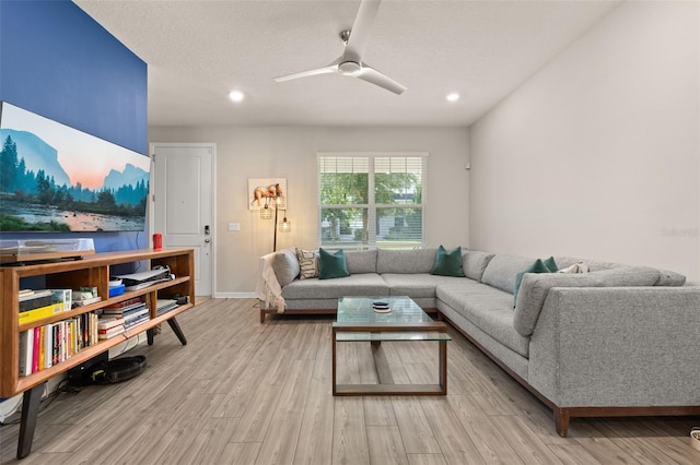 living area with wood finished floors, a ceiling fan, recessed lighting, and baseboards