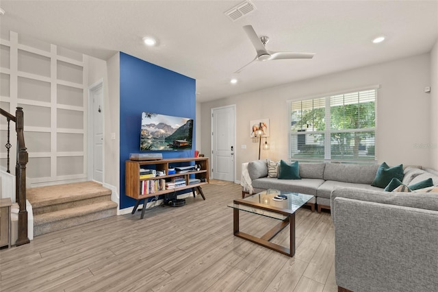 living area with stairs, light wood finished floors, ceiling fan, recessed lighting, and baseboards