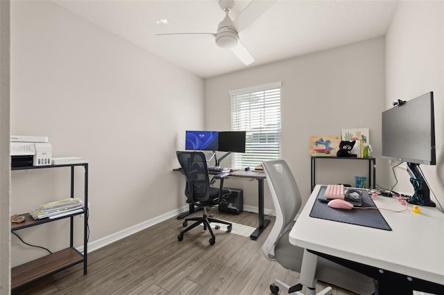 home office featuring ceiling fan, wood finished floors, and baseboards