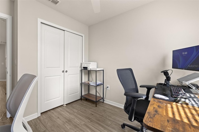 home office with wood finished floors, baseboards, and a ceiling fan