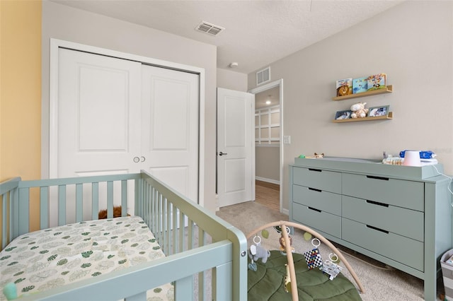 bedroom with light colored carpet, a closet, and baseboards