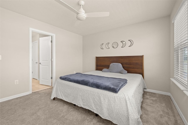 bedroom with carpet floors, a ceiling fan, and baseboards