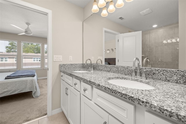 full bath featuring baseboards, ensuite bath, ceiling fan, and double vanity