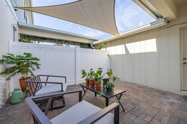 view of patio / terrace featuring fence