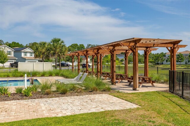 view of property's community featuring a patio area, a pool, and a pergola