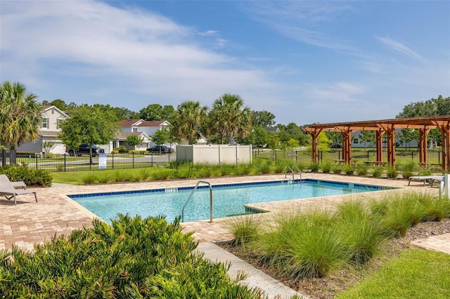 community pool featuring fence and a patio
