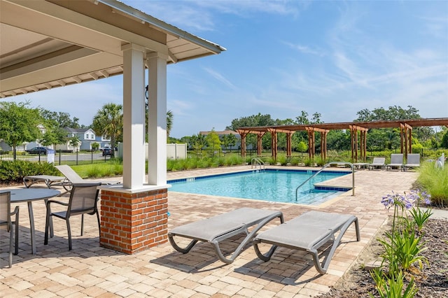 community pool featuring a patio area, fence, and a pergola