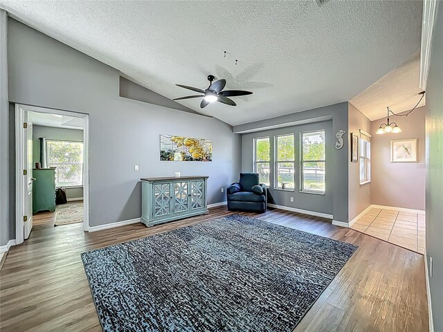 sitting room featuring a wealth of natural light, a textured ceiling, and lofted ceiling