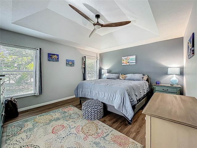 bedroom with baseboards, a ceiling fan, and wood finished floors