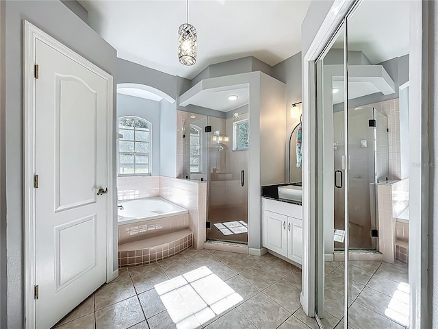 full bathroom featuring vanity, a bath, and a shower stall