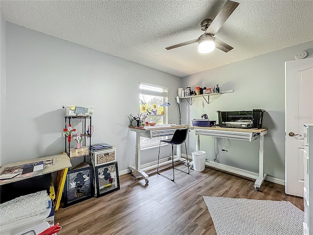 home office with baseboards, a ceiling fan, a textured ceiling, and wood finished floors