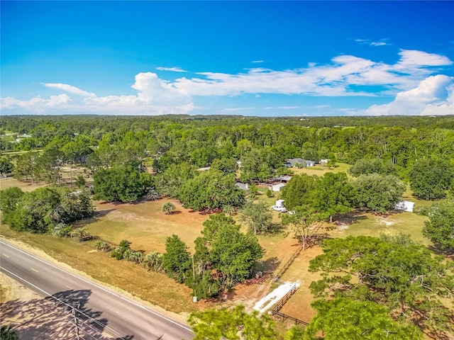 drone / aerial view featuring a view of trees