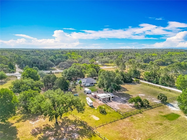 drone / aerial view featuring a wooded view