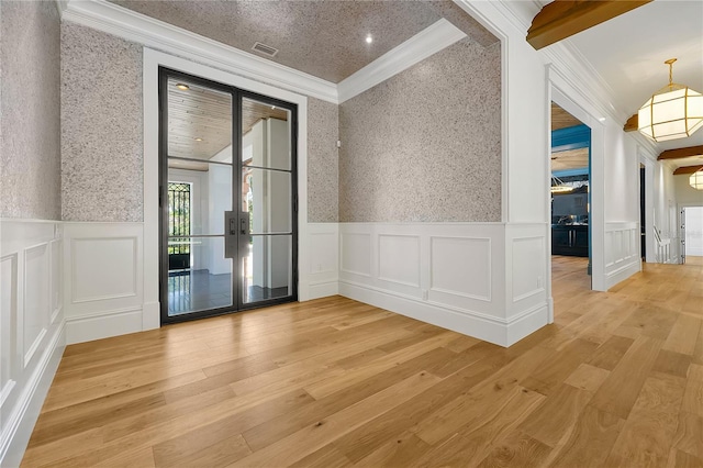 5525 Isleworth Country Club Dr, Windermere, FL 34786 - spare room with crown molding, wainscoting, a decorative wall, light wood-type flooring, and french doors