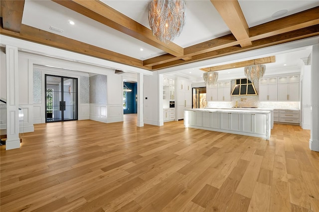 5525 Isleworth Country Club Dr, Windermere, FL 34786 - unfurnished living room with a chandelier, beam ceiling, a decorative wall, light wood finished floors, and recessed lighting