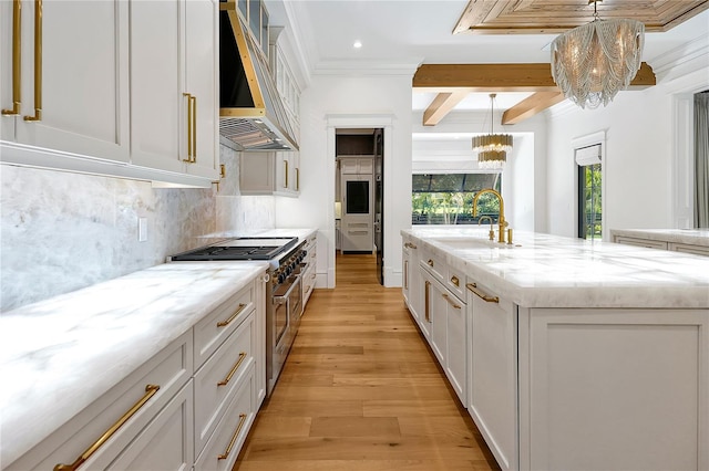 5525 Isleworth Country Club Dr, Windermere, FL 34786 - kitchen with a chandelier, double oven range, range hood, a sink, and light wood finished floors
