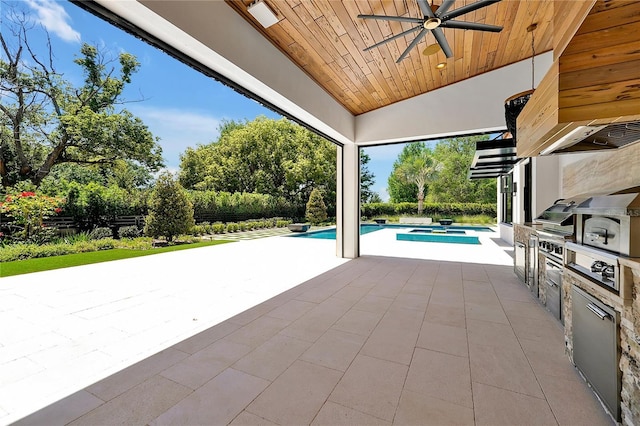 5525 Isleworth Country Club Dr, Windermere, FL 34786 - view of patio / terrace featuring a ceiling fan, an outdoor kitchen, an outdoor pool, and view of wooded area