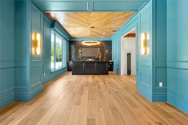 5525 Isleworth Country Club Dr, Windermere, FL 34786 - unfurnished living room with a decorative wall, light wood-type flooring, wooden ceiling, crown molding, and a chandelier