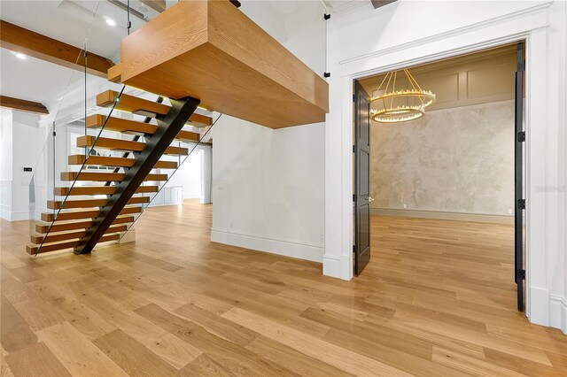 5525 Isleworth Country Club Dr, Windermere, FL 34786 - unfurnished living room with light wood-type flooring, a chandelier, baseboards, stairway, and beamed ceiling