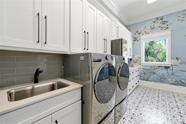 5525 Isleworth Country Club Dr, Windermere, FL 34786 - laundry area with cabinet space, washer and dryer, crown molding, baseboards, and light tile patterned flooring