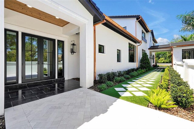 5525 Isleworth Country Club Dr, Windermere, FL 34786 - entrance to property featuring stucco siding, french doors, and a patio